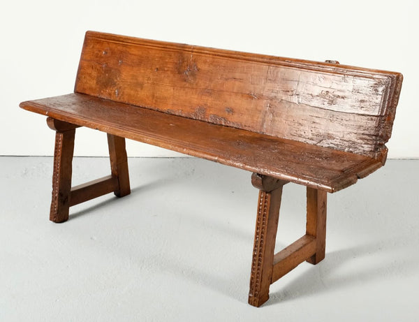 Carved antique trestle leg village bench, walnut