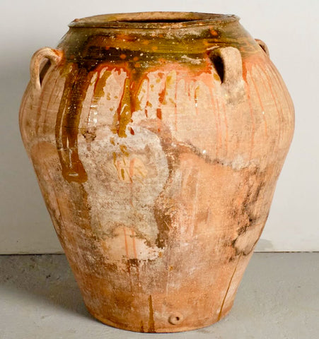 Antique crimped terracotta oil jar on iron base