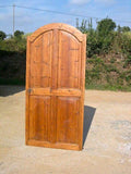 Single-panel honey pine arched door