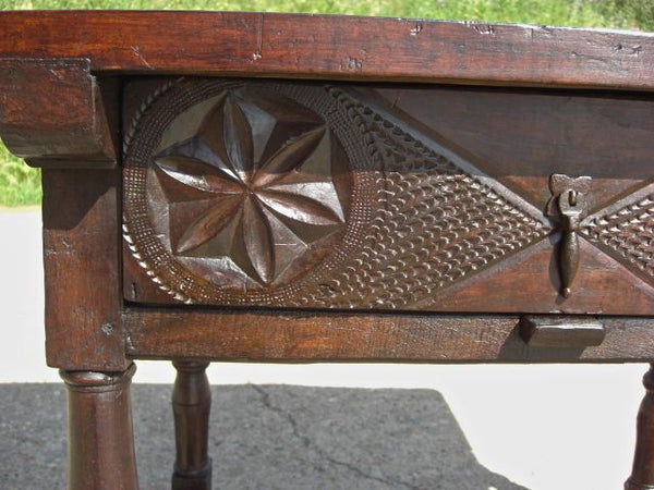 Turned-leg carved-drawer table in walnut and oak