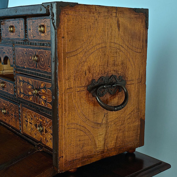 Antique inlaid vargueño on lentil leg table with iron stretchers