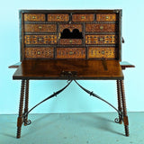 Antique inlaid vargueño on lentil leg table with iron stretchers