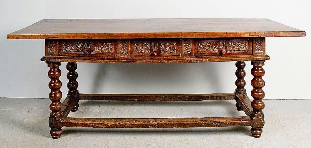 Antique carved three-drawer library table with beaded turned legs, walnut