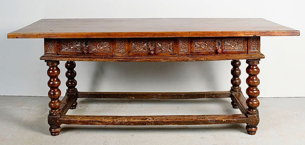 Antique carved three-drawer library table with beaded turned legs, walnut