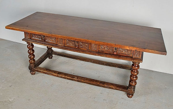 Antique carved three-drawer library table with beaded turned legs, walnut