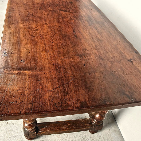 Antique carved three-drawer library table with beaded turned legs, walnut