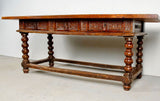 Antique carved three-drawer library table with beaded turned legs, walnut