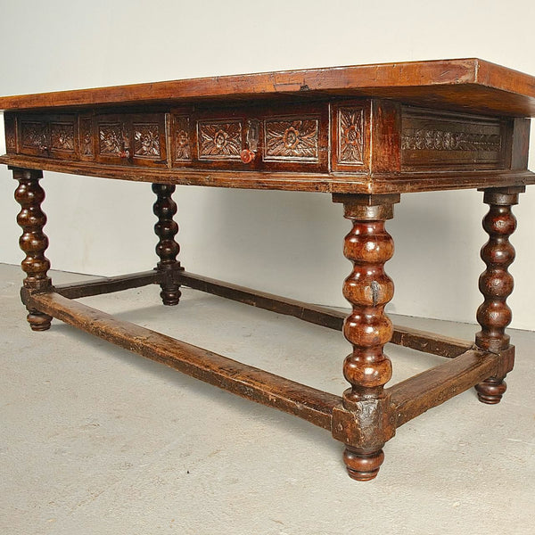 Antique carved three-drawer library table with beaded turned legs, walnut