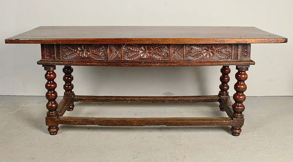 Antique carved three-drawer library table with beaded turned legs, walnut