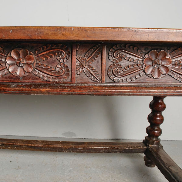 Antique carved three-drawer library table with beaded turned legs, walnut