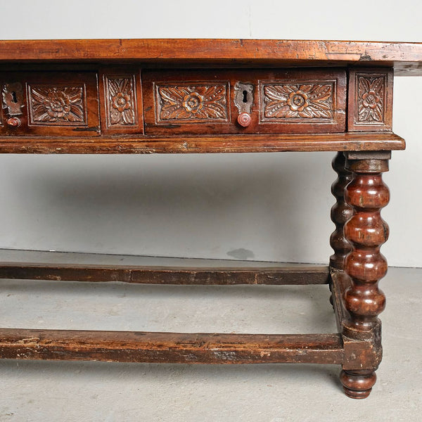 Antique carved three-drawer library table with beaded turned legs, walnut