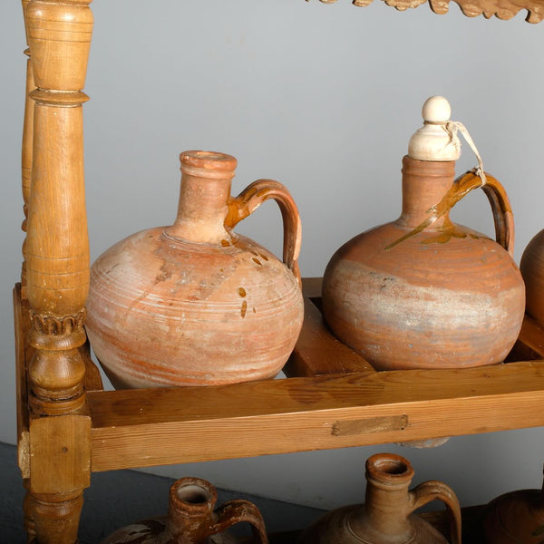 Antique two-tier, six hole water jug stand with original clay jugs, pine