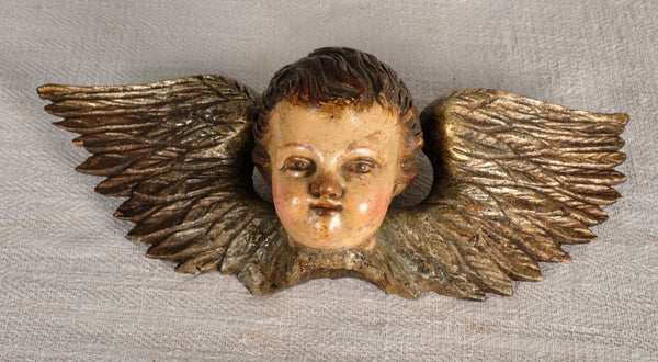 Antique carved, silvered and polychromed cherub