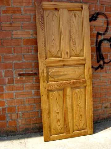 Antique carved single-panel Pyrenees door with raised diamond moldings, honey pine