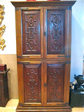 Carved reproduction four-door cabinet with Renaissance chain carving, cachimbo hardwood and reclaimed walnut