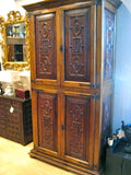Carved reproduction four-door cabinet with Renaissance chain carving, cachimbo hardwood and reclaimed walnut