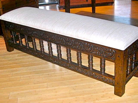 Reproduction carved and upholstered "Cusco" Spanish colonial bench, cachimbo hardwood