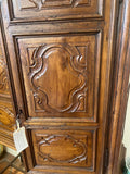 Antique two-door carved walnut cabinet on iron stand