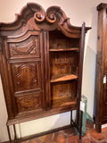 Antique two-door carved walnut cabinet on iron stand