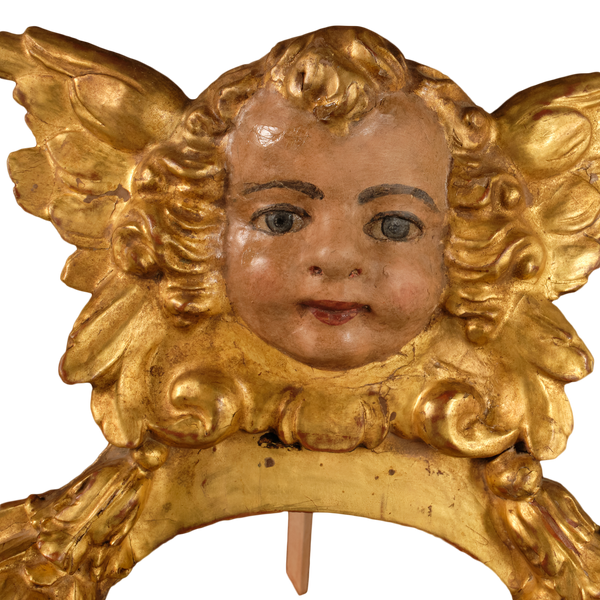 Antique carved, gilt and polychromed angel head with pomegranates