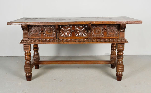 Antique heavily carved turned leg three-drawer library table, walnut