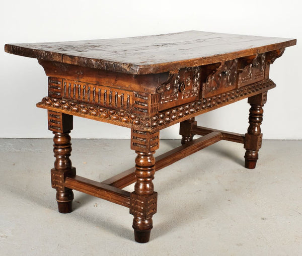Antique heavily carved turned leg three-drawer library table, walnut