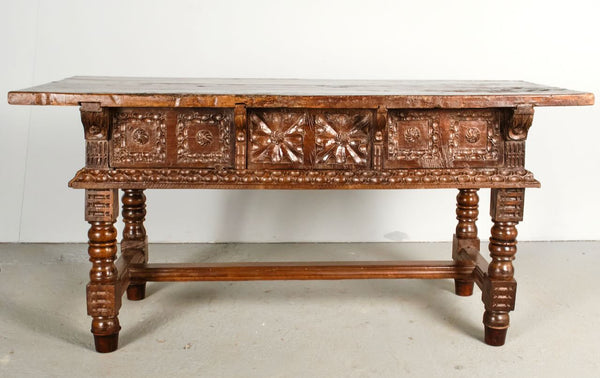 Antique heavily carved turned leg three-drawer library table, walnut