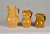 Antique set of three glazed ribbon mouth wine pitchers