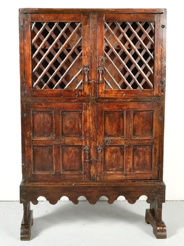 Small antique scalloped skirt four-door pantry cabinet with latticework doors, mixed woods