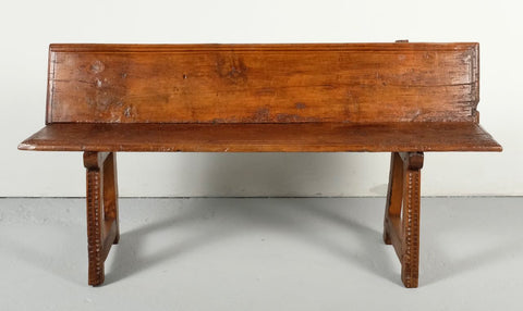 Carved antique trestle leg village bench, walnut