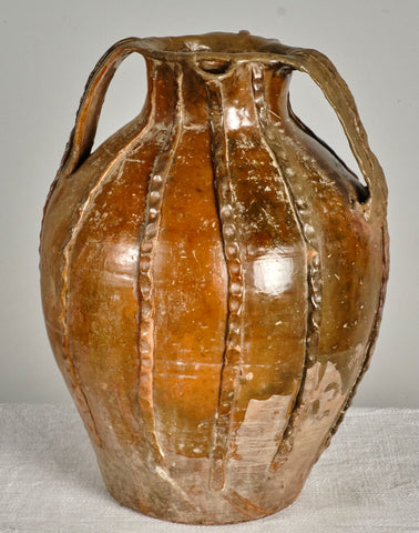 Large antique three-handle braided oil pitcher