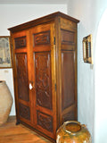 Reproduction two-door carved panel Basque armoire, walnut and cachimbo hardwood