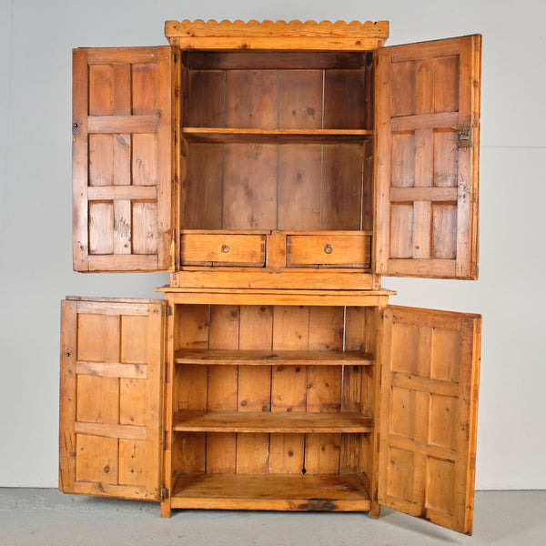 Antique scalloped cornice four door Pyrenees cabinet, pine