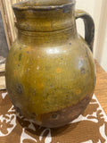 Single-handle, semi-glazed olive green oil pitcher