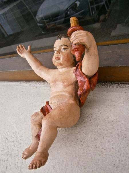 Antique carved and painted cherubs