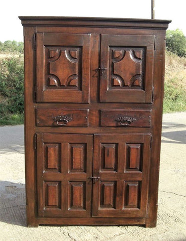 Antique two-door carved walnut cabinet on iron stand