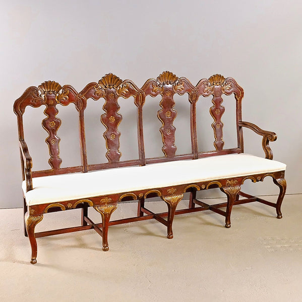 Antique painted and gilt upholstered four-seat Chippendale bench