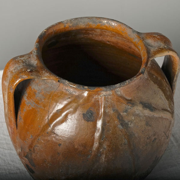 Antique two handle semi-glazed pot with braided decoration
