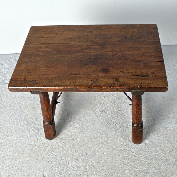 Antique mast leg accent table with iron stretchers, walnut