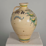 Large antique painted and glazed single handle water jug, “Blue and green flower with pomegranate on shield”