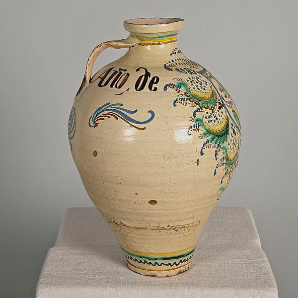 Large antique painted and glazed single handle water jug, “Blue and green flower with pomegranate on shield”