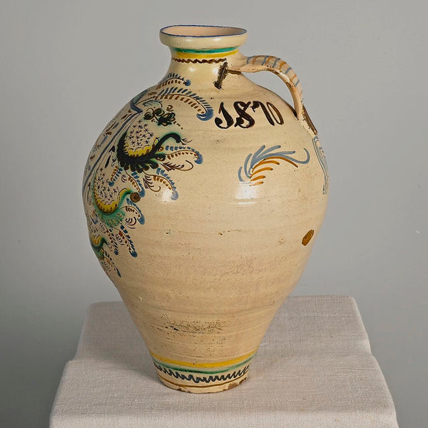 Large antique painted and glazed single handle water jug, “Blue and green flower with pomegranate on shield”