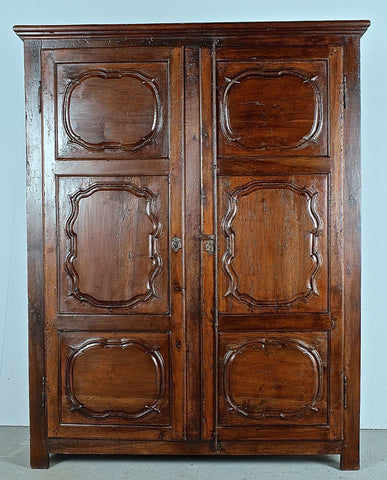 Antique two-door carved walnut cabinet on iron stand