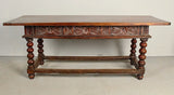 Antique carved three-drawer library table with beaded turned legs, walnut