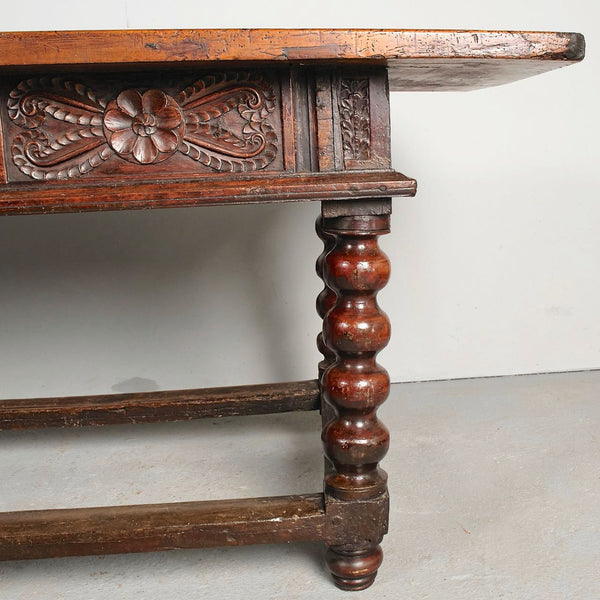 Antique carved three-drawer library table with beaded turned legs, walnut