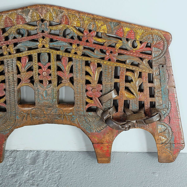 Antique polychromed oxen yoke with carved fans and florals, holm oak