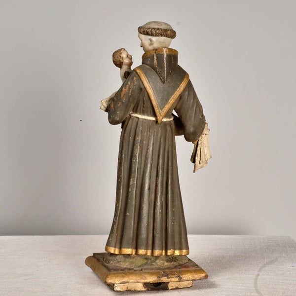 Antique carved and painted wood sculpture of Saint Anthony with child