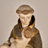 Antique carved and painted wood sculpture of Saint Anthony with child