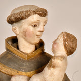 Antique carved and painted wood sculpture of Saint Anthony with child