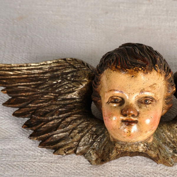 Antique carved, silvered and polychromed cherub